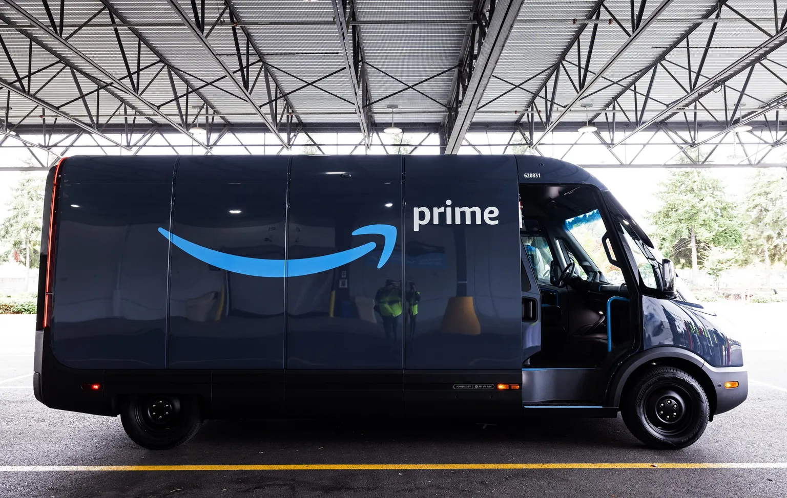 An Amazon Prime electric delivery van staged at a fleet depot