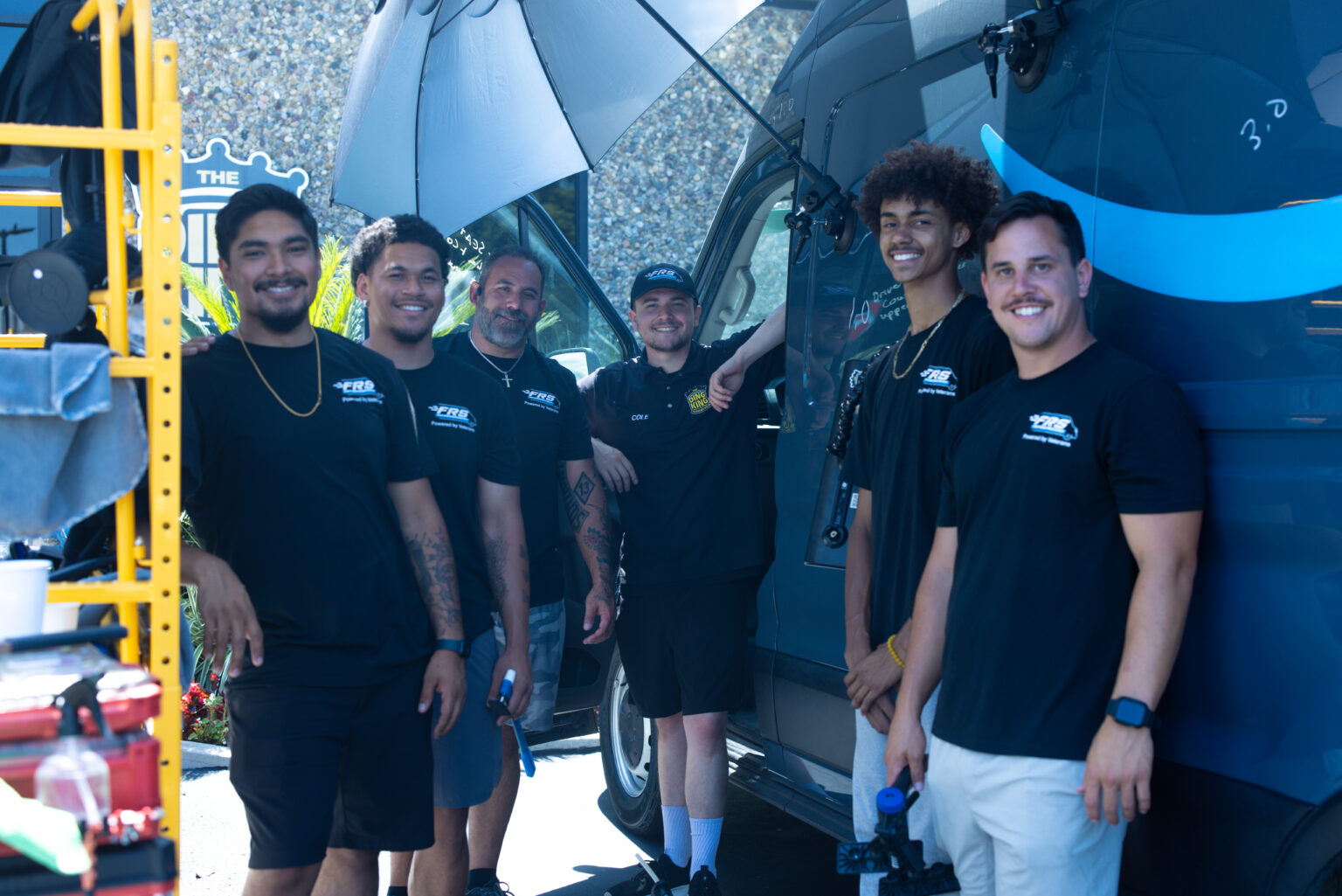 A team of FRS fleet reconditioning technicians beside a commercial delivery van